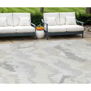 Photo of Ivory Beige And Cream Abstract Washable Indoor Outdoor Area Rug