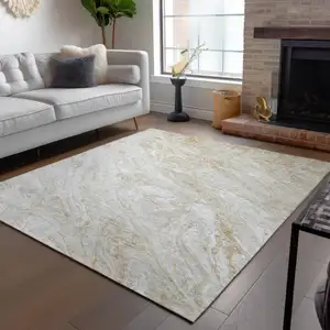 Photo of Ivory Beige And Tan Abstract Washable Indoor Outdoor Area Rug