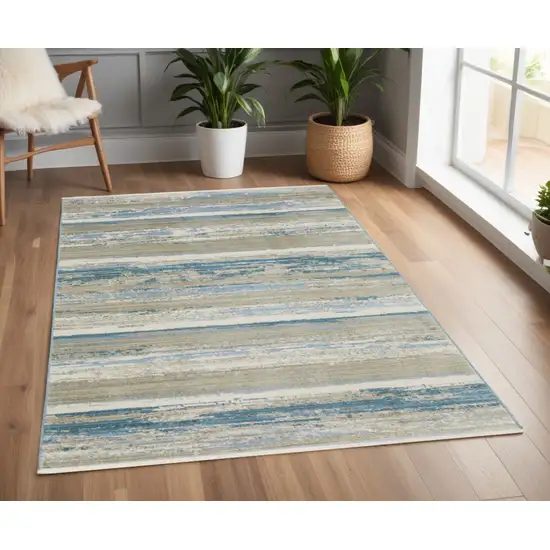 Ivory Beige Grey Blue And Tan Abstract Power Loom Stain Resistant Area Rug With Fringe Photo 1