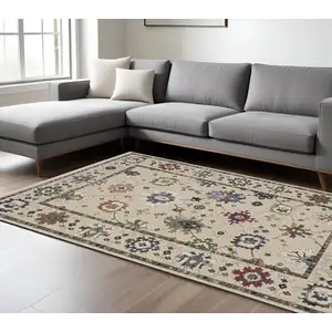 Photo of Ivory Blue And Light Brown Floral Area Rug With Fringe