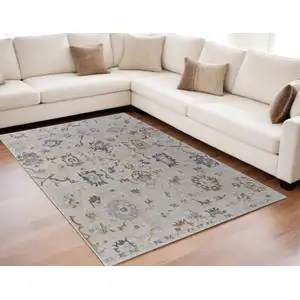 Photo of Ivory Blue and Gold Floral Power Loom Worn Faded Area Rug With Fringe