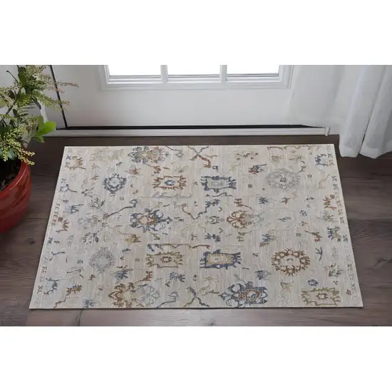 Ivory Blue and Gold Floral Power Loom Worn Faded Area Rug With Fringe Photo 1