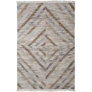 Photo of Ivory Gray And Tan Geometric Hand Woven Stain Resistant Area Rug With Fringe