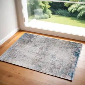 Photo of Ivory Gray and Blue Abstract Power Loom Area Rug With Fringe