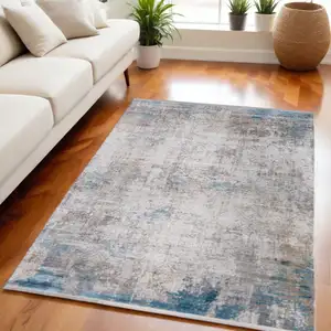 Photo of Ivory Gray and Blue Abstract Power Loom Area Rug With Fringe