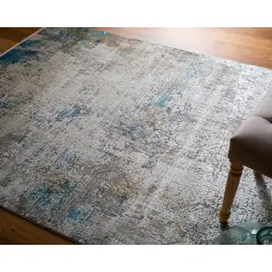 Photo of Ivory Gray and Blue Abstract Power Loom Area Rug With Fringe