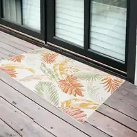 Photo of Ivory Green and Orange Palm Leaf Stain Resistant Indoor Outdoor Area Rug