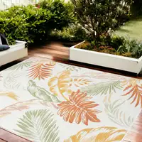 Photo of Ivory Green and Orange Palm Leaf Stain Resistant Indoor Outdoor Area Rug