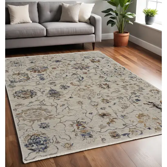 Ivory and Blue Floral Power Loom Distressed Non Skid Area Rug With Fringe Photo 1