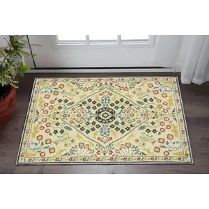 Photo of Ivory Orange And Yellow Oriental Area Rug With Fringe