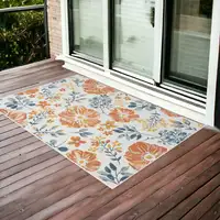 Photo of Ivory Orange and Blue Floral Stain Resistant Indoor Outdoor Area Rug