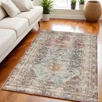 Photo of Ivory Red And Orange Geometric Distressed Area Rug