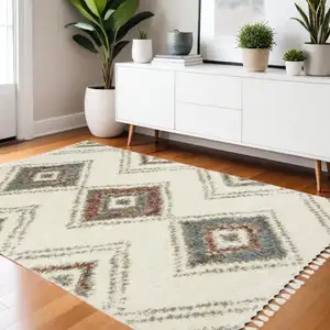 Photo of Ivory Red And Orange Southwestern Shag Area Rug With Fringe