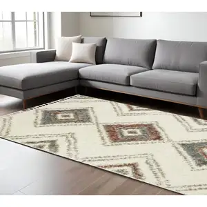 Photo of Ivory Red And Orange Southwestern Shag Area Rug With Fringe