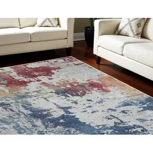 Photo of Ivory Red and Blue Abstract Distressed Non Skid Area Rug