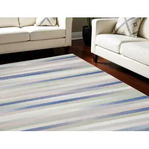 Photo of Ivory Tan and Blue Abstract Distressed Non Skid Area Rug