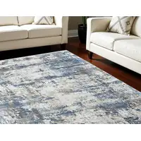 Photo of Ivory Tan and Blue Abstract Power Loom Area Rug With Fringe