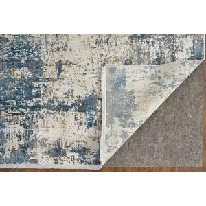 Photo of Ivory Tan and Blue Abstract Power Loom Area Rug With Fringe