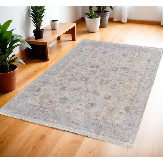 Ivory Tan and Blue Floral Hand Woven Distressed Area Rug With Fringe Photo 1