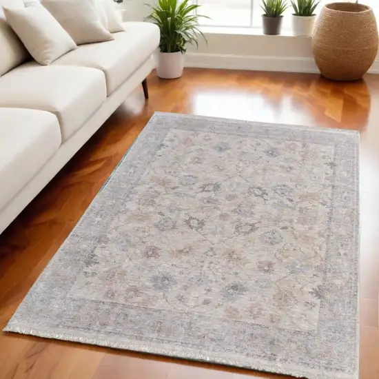 Ivory Tan and Blue Floral Hand Woven Distressed Area Rug With Fringe Photo 1