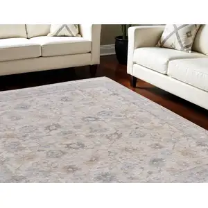 Photo of Ivory Tan and Blue Floral Hand Woven Distressed Area Rug With Fringe