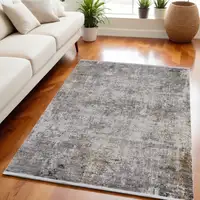 Photo of Ivory Taupe and Gray Abstract Power Loom Distressed Area Rug With Fringe