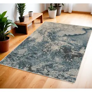 Photo of Ivory Teal Blue and Black Abstract Area Rug