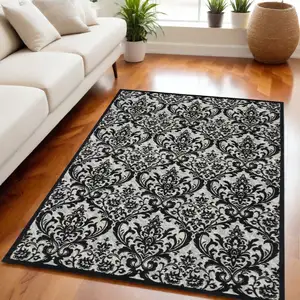 Photo of Ivory and Black Damask Distressed Area Rug