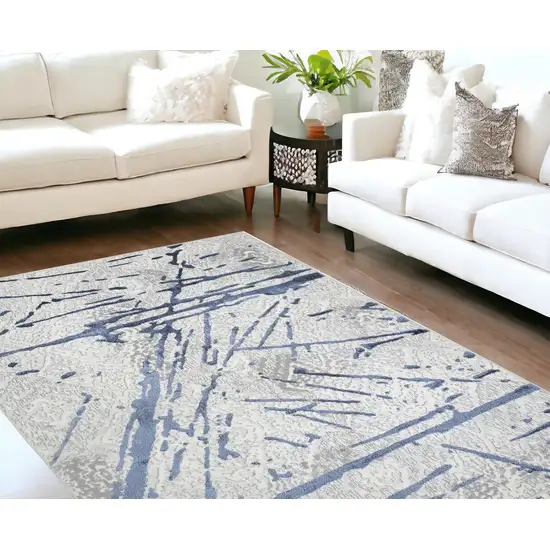 Ivory and Blue Abstract Area Rug Photo 1