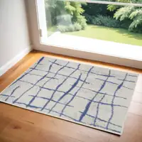 Photo of Ivory and Blue Abstract Distressed Area Rug