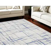 Photo of Ivory and Blue Abstract Distressed Non Skid Area Rug