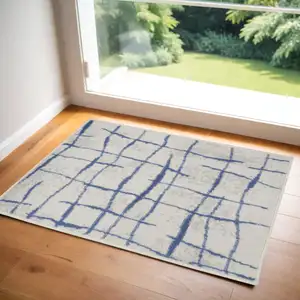 Photo of Ivory and Blue Abstract Geometric Distressed Area Rug