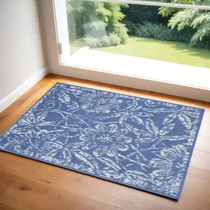 Photo of Ivory and Blue Floral Distressed Area Rug