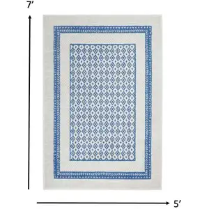 Photo of Ivory and Blue Geometric Area Rug