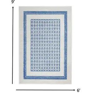 Photo of Ivory and Blue Geometric Area Rug