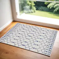 Photo of Ivory and Blue Geometric Area Rug