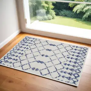 Photo of Ivory and Blue Geometric Area Rug