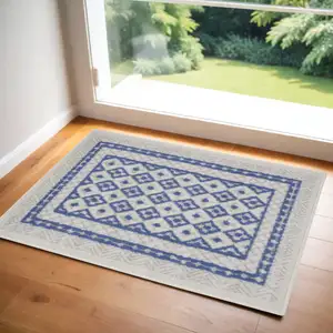 Photo of Ivory and Blue Geometric Distressed Area Rug