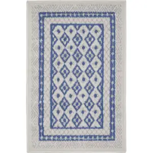 Photo of Ivory and Blue Geometric Distressed Area Rug