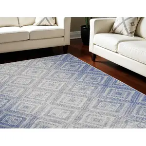 Photo of Ivory and Blue Geometric Distressed Non Skid Area Rug