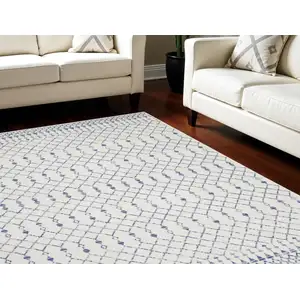 Photo of Ivory and Blue Geometric Distressed Non Skid Area Rug