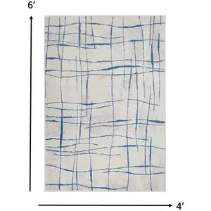 Photo of Ivory and Blue Irregular Grids Area Rug