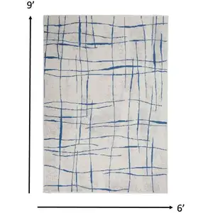 Photo of Ivory and Blue Irregular Grids Area Rug