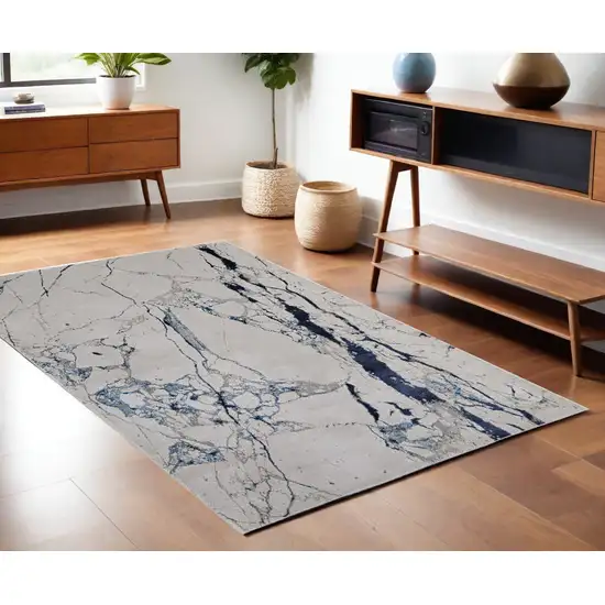 Ivory and Blue Marble Power Loom Distressed Area Rug Photo 1