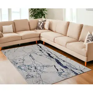 Photo of Ivory and Blue Marble Power Loom Distressed Area Rug