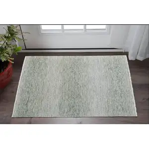 Photo of Ivory and Green Wool Hand Knotted Area Rug With Fringe