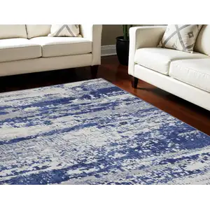 Photo of Ivory and Navy Blue Abstract Distressed Non Skid Area Rug