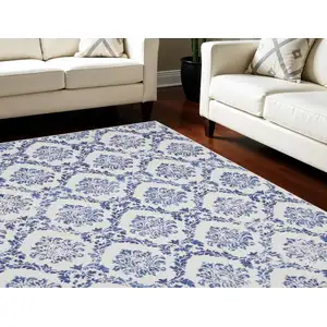 Photo of Ivory and Navy Blue Damask Distressed Non Skid Area Rug