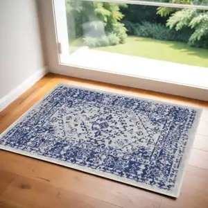 Photo of Ivory and Navy Blue Geometric Distressed Area Rug