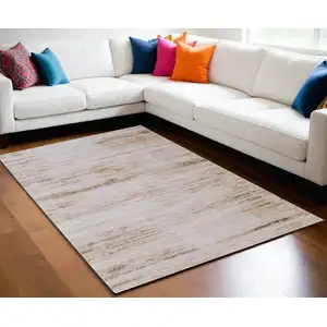 Photo of Ivory and Tan Abstract Power Loom Worn Faded Area Rug